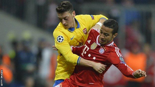 Bayern Munich's Spanish midfielder Thiago Alcantara and Arsenal's German midfielder Mesut Ozil