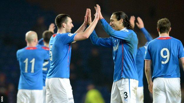 Rangers players celebrate securing the League One title