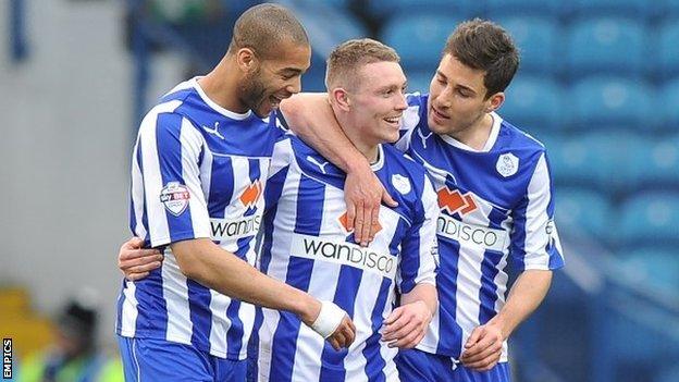 Wednesday players celebrate with Caolan Lavery after he scored their fourth goal