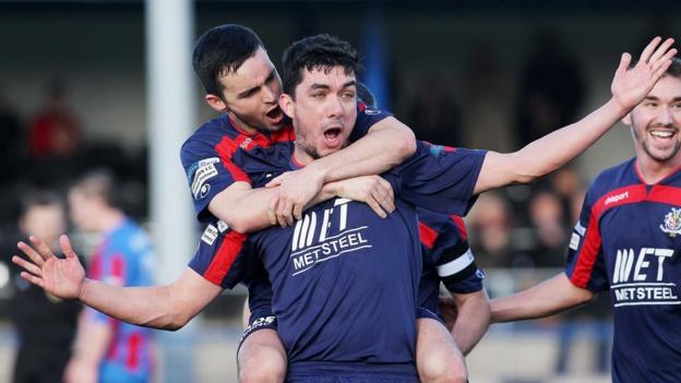 Portadown players congratulate Emmett Friars after he scores the winning goal against Ards at Clandeboye Park