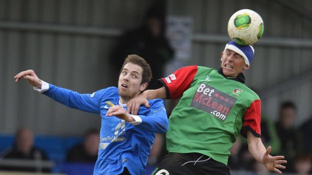 Richard Lecky and Jay Magee in aerial action during Glentoran's 3-0 win over Ballinamallard United