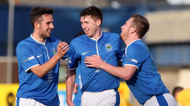 Andy Waterworth and Mark McAllister congratulate Billy Joe Burns after his goal completed a 3-0 win for the Blues