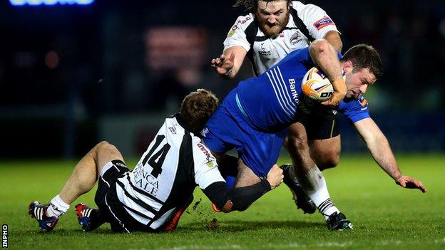 Fergus McFadden is tackled by Giulio Toniolatti and David Ryan at the RDS