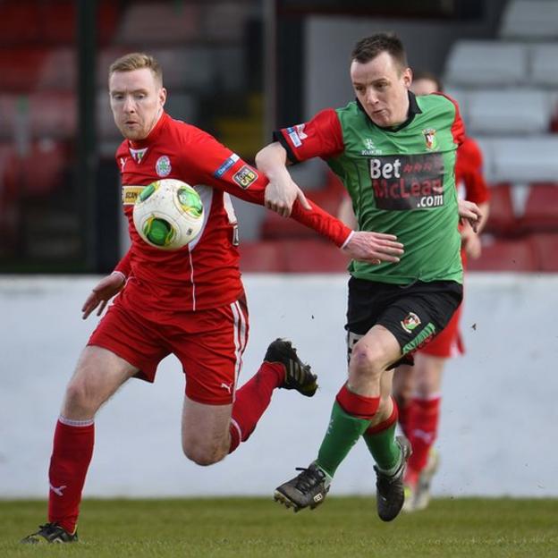 Cliftonville's Chris Curran and Jason Hill of Glentoran go for the ball during the 0-0 draw at the Oval