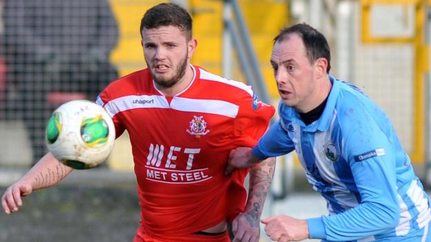 Portadown forward Darren Murray and Jonathan Cowan of Warrenpoint keep their eyes on the ball during the Premiership clash at Shamrock Park
