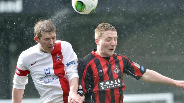 Ross Arthurs of Ards goes up for the ball with Chris Morrow at Seaview where Crusaders came out on top 4-1