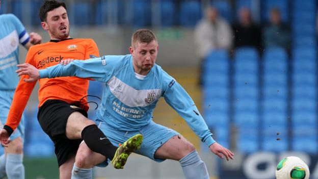 Brian McCaul of Glenavon challenges David Cushley during Ballymena United's 2-1 victory at the Showgrounds