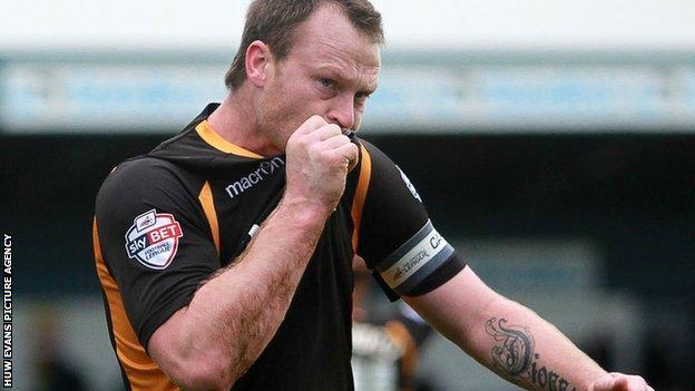 Michael Flynn kisses the Newport County badge
