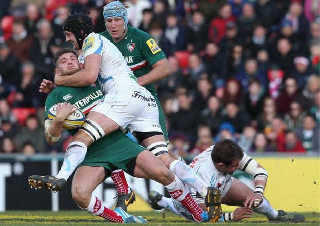 Leicester fly-half Owen Williams is high tackled by Exeter's Dean Mumm in the he Aviva Premiership match at Welford Road