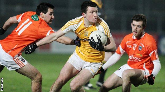 Antrim's Dermot McAleese in action against Armagh's Micheal McKenna and Callum Comiskey