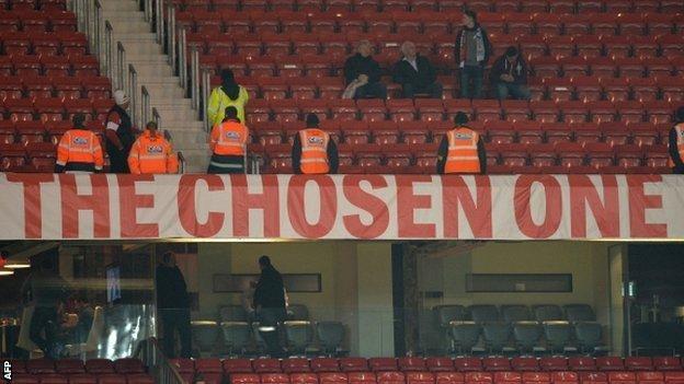 Stewards guard the Chosen One banner at Old Trafford on Tuesday