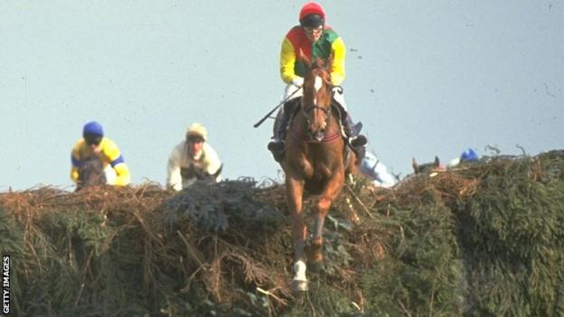 Mr Frisk, ridden by Marcus Armytage, jumps a fence on the way to victory in the 1990 Grand National