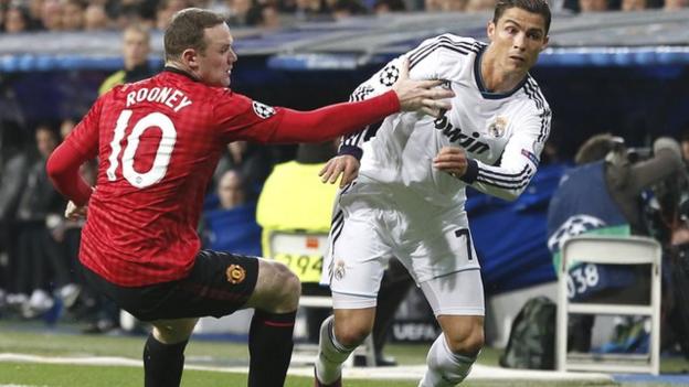 Cristiano Ronaldo (right) pushes the ball past Wayne Rooney during Real Madrid's Champions League victory over Manchester United in 2013