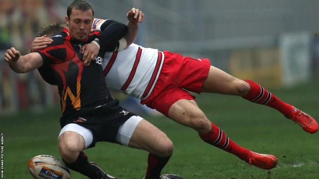 Newport Gwent Dragons scrum-half Richie Rees, in action against former club Edinburgh, is tackled by Tom Brown in the rearranged Pro12 match at Rodney Parade.