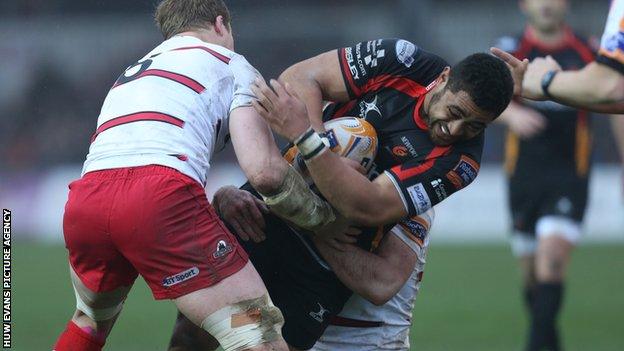 Dragons' Taulupe Faletau is tackled by Edinburgh's David Denton and Mike Coman