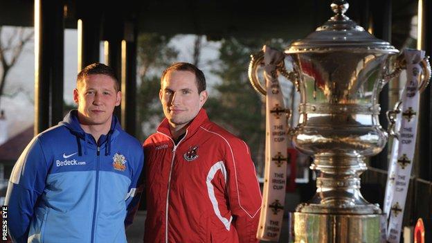 Glenavon defender Kris Lindsay and Crusaders keeper Sean O'Neill with the Irish Cup