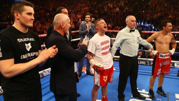 Frampton's trainer Shane McGuigan and manager Barry McGuigan join the celebrations as the super-bantamweight lets his emotions show after the impressive second-round victory