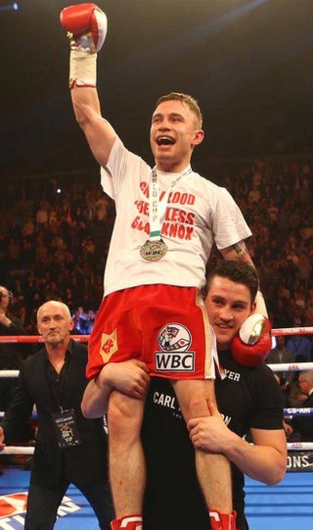 Frampton gets a helping hand from trainer Shane McGuigan to salute his army of delighted fans at the Odyssey