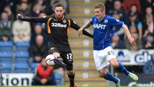 In League Two, Newport County’s Robbie Willmott tries to shield the ball away from Chesterfield midfielder Daniel Kearns.