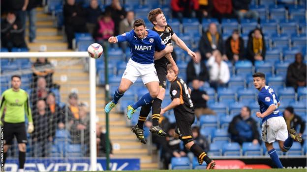 Sam Hird of Chesterfield and Kevin Feely of Newport County go airborne during the 1-1 draw between the two League Two sides