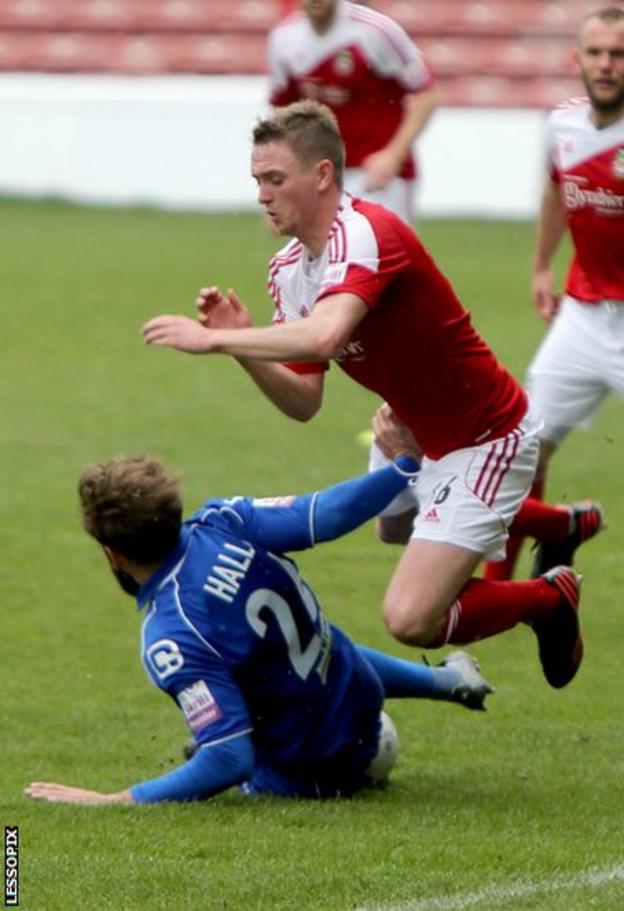 Wrexham goalscorer and man of the match Johnny Hunt is brought down by Macclesfield’s Andy Halls in the Conference Premier game at the Racecourse.