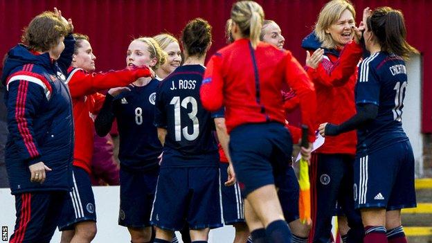 Scotland coach Anna Signeul celebrates with her players at Fir Park