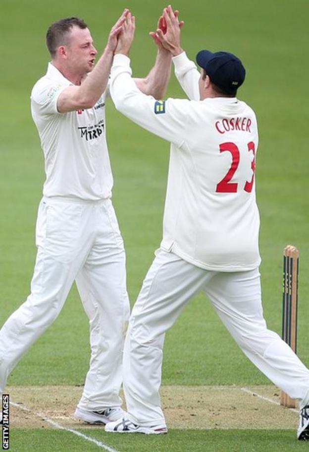 Graeme Wagg is congratulated by Dean Cosker after taking the wicket of Surrey's Graeme Smith during the first innings of Glamorgan’s opening County Championship game of the season.