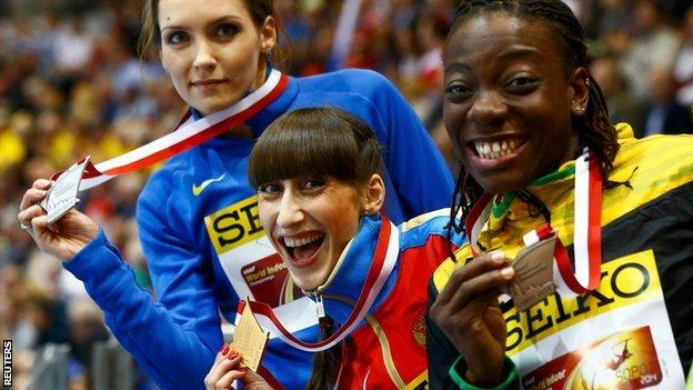 Medallists Ukraine's Saladukha Russia's Koneva and Jamaica's Williams celebrate after women"s triple jump final at world indoor athletics championships in Sopot