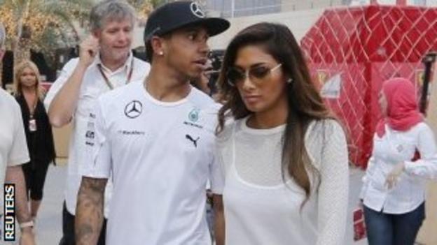 Mercedes Formula 1 driver Lewis Hamilton of Britain walks with his girlfriend Nicole Scherzinger