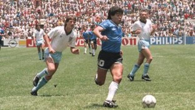 Diego Maradona powers through the England defence to score for Argentina