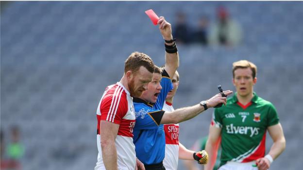 Referee Padraig Hughes sends off Fergal Doherty during the first half of the League semi-final