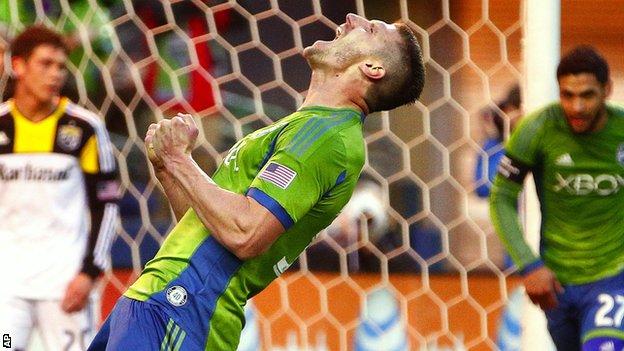 Seattle Sounders midfielder Kenny Cooper celebrates after scoring