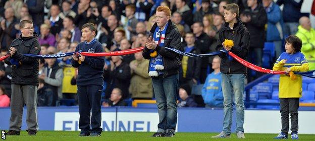 Everton supporters join their scarves with Liverpool FC scarves to mark the 25th anniversary of the Hillsborough disaster before the game.
