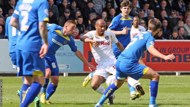 Chris Zebroski scores Newport County’s opening goal in their Good Friday game at AFC Wimbledon in League Two.