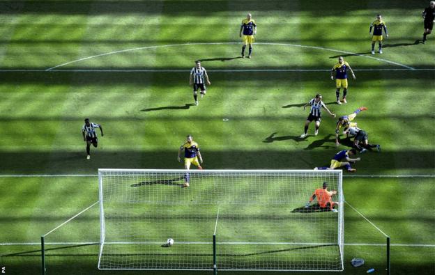 Newcastle's Shola Ameobi scores his sides opening goal against the Swans