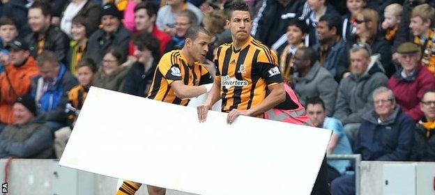 Jake Livermore helps clear the pitch