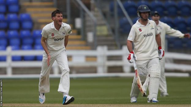 Gloucestershire's David Payne celebrates after Mark Wallace is out for a golden duck as Glamorgan end a rain affected day on 47 for 6