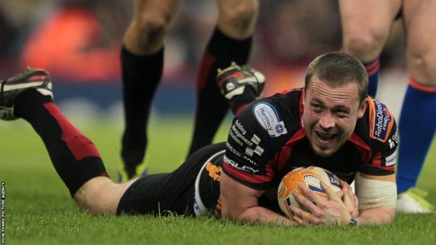 Dragons scrum-half Richie Rees dives over to give his side the lead against the Ospreys at the Millennium Stadium