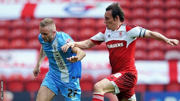 Dean Whitehead of Middlesbrough (left) challenges Barnsley's Ryan McLaughlin