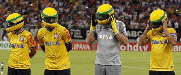 Corinthians players wear replicas of the helmet worn by Senna before the start of their Copa do Brasil match against rival club Nacional