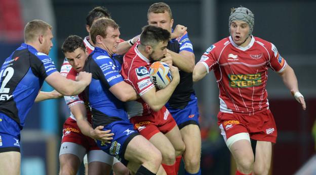 Jordan Williams runs into trouble from the Dragons defence in Scarlets' 34-23 win in the Pro12