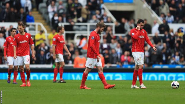Cardiff's players are dejected as their 3-0 defeat leaves them relegated to the Championship for next season