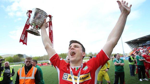 Diarmuid O'Carroll holds the Gibson Cup after Cliftonville's Premiership title triumph this year