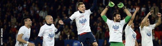 Paris St-Germain players take the acclaim of their supporters after winning their second straight Ligue 1 title