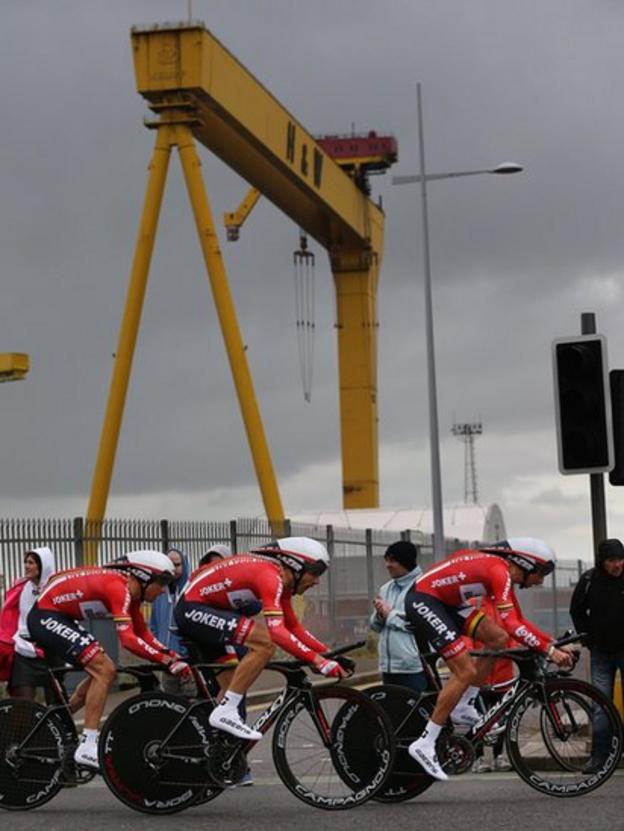 Members of the Belgian team Lotto Belison pass one of the famous Harland and Wolff shipyard cranes shortly after the team trial start at Titanic Quarter