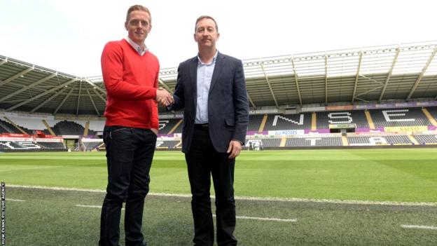 Garry Monk shakes the hand of chairman Huw Jenkins after he was confirmed as Swansea City’s permanent manager.