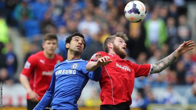 Chelsea winger Mohamed Salah battles for the ball with Cardiff City midfielder Aron Gunnarsson on the final day of the Premier League season at Cardiff City Stadium.
