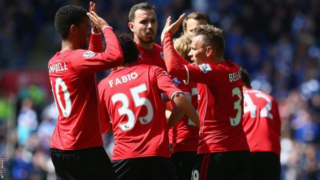 Craig Bellamy celebrates with his Cardiff City team-mates after giving his side the lead against Chelsea.