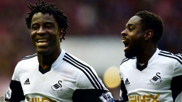 Wilfried Bony (l) and Nathan Dyer celebrate Swansea's third goal