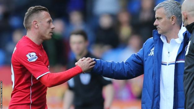 Craig Bellamy shakes the hand of Chelsea manager Jose Mourinho as he leaves the Cardiff City Stadium pitch.